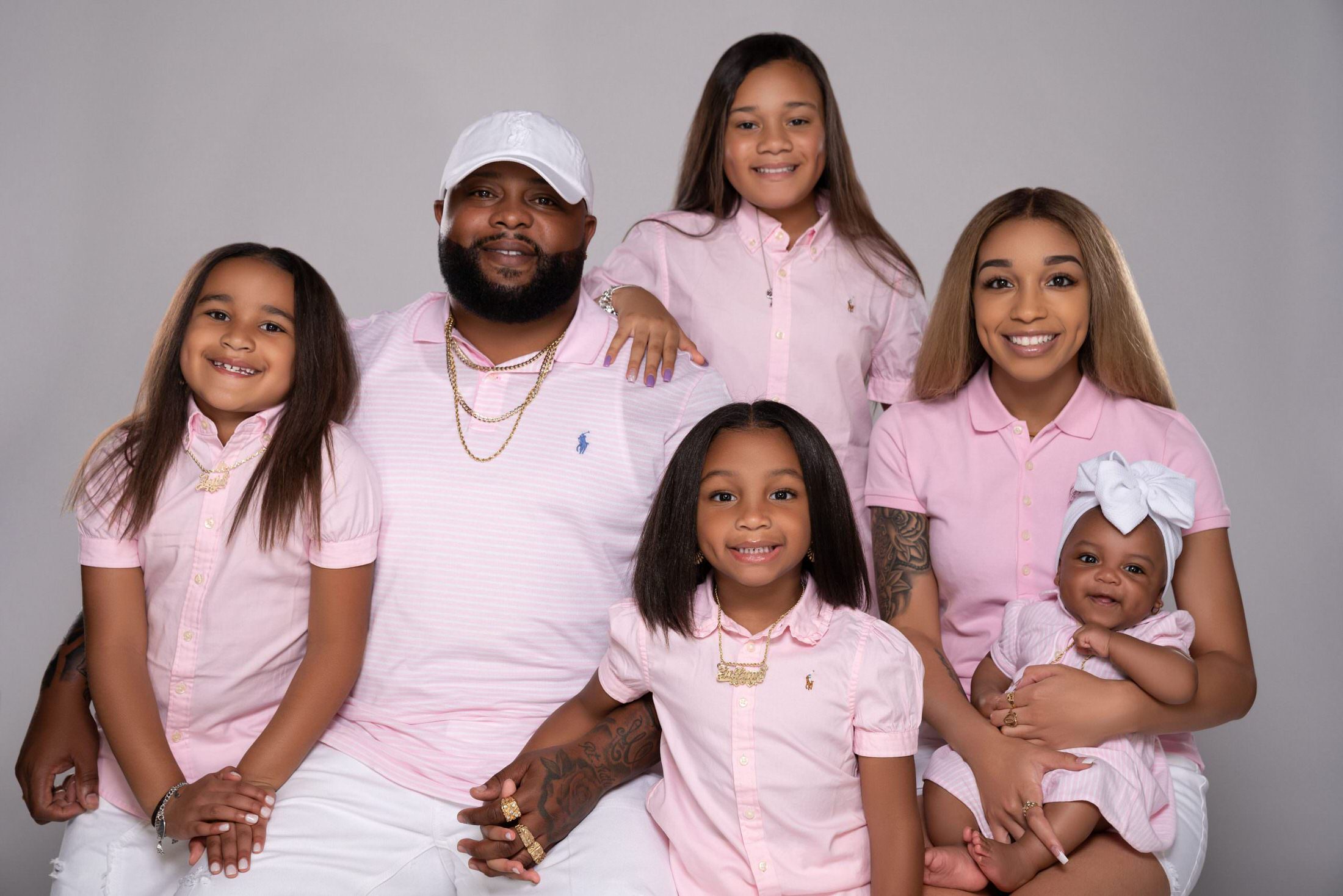 Black family pink outfit photo session in studio